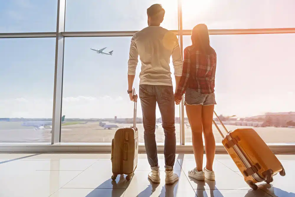 couple holding hands at airport