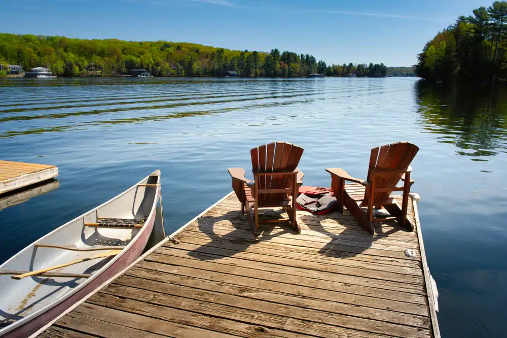 wooden dock with chairs and canoe