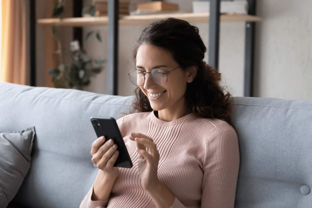 woman smiling using phone