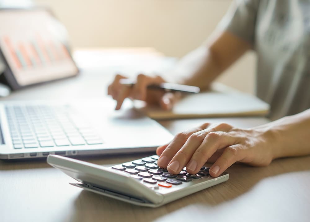 man with calculator and laptop