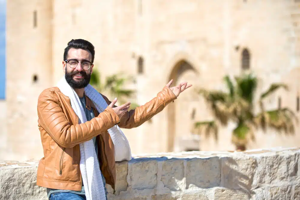 man gesturing to a historical site