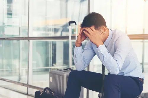 man stressed at the airport