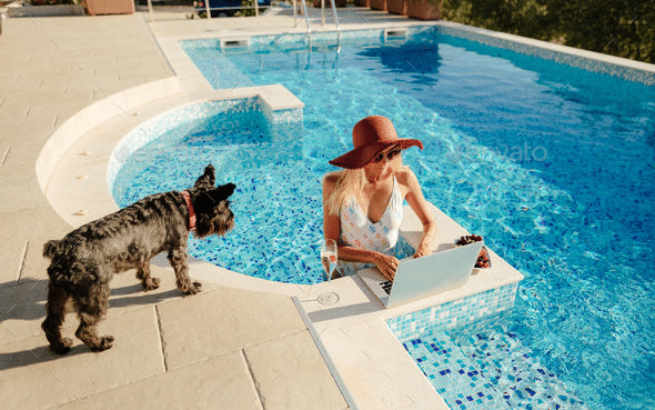 woman working in pool with dog