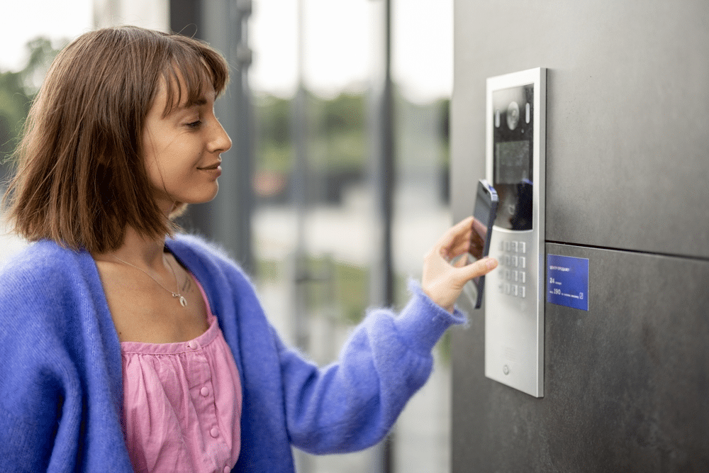 woman using phone for building entry