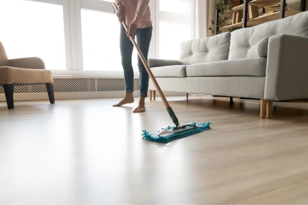 person mopping wood floor