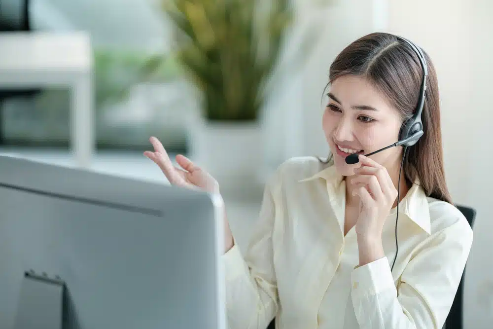 Woman with headset gesturing.